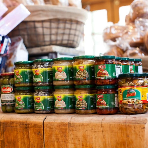 Jars of Celli brand Mediterranean capers, chopped sauteed onions, Sicilian artichokes, and semi-dry cherry tomatoes.